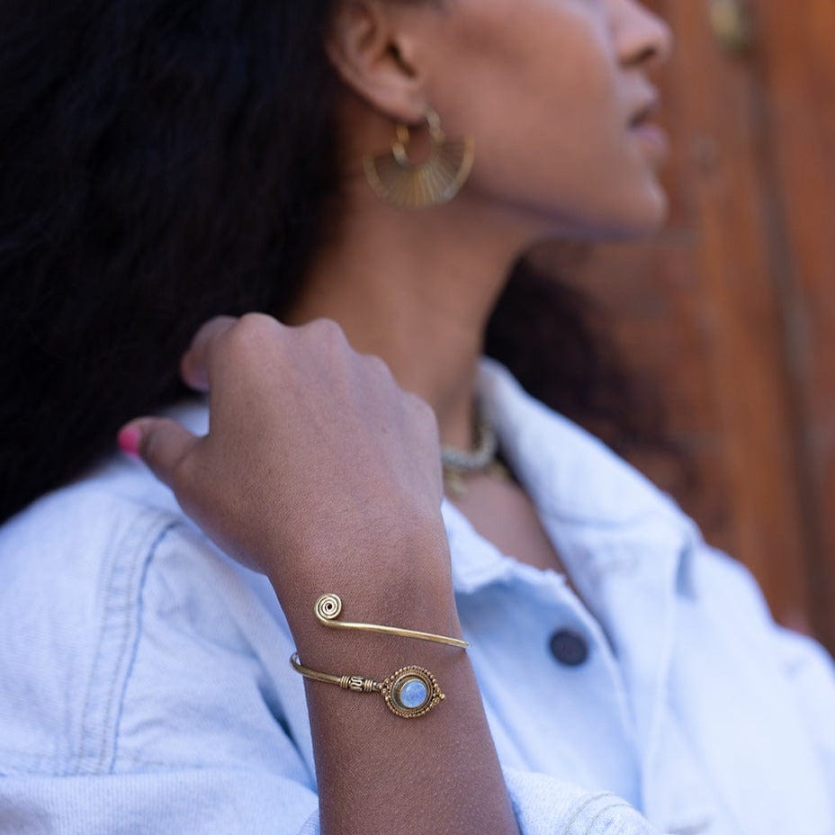 Woman styling Daya crystal jewelry and a labradorite bracelet