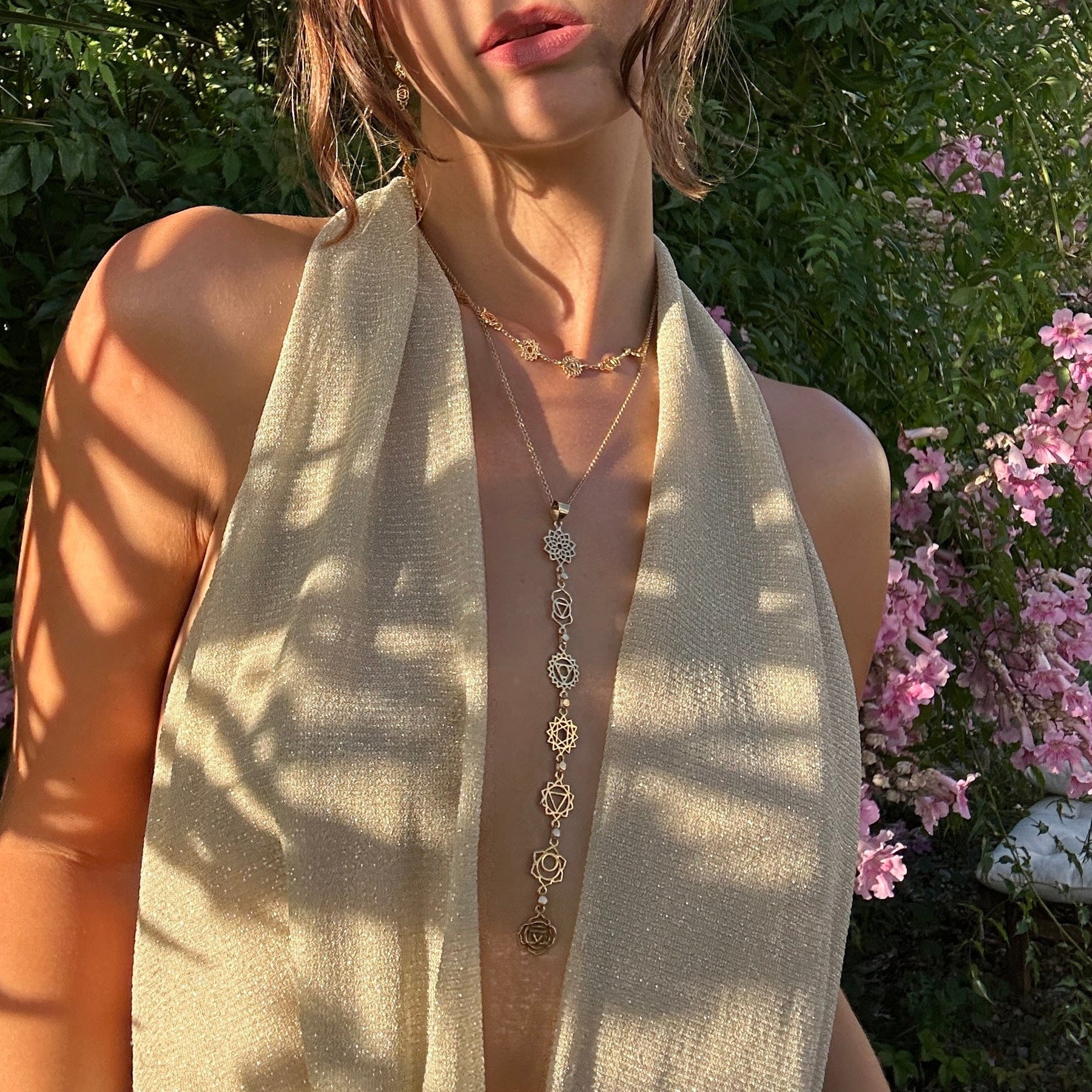 Woman wearing layered Daya chakra jewelry